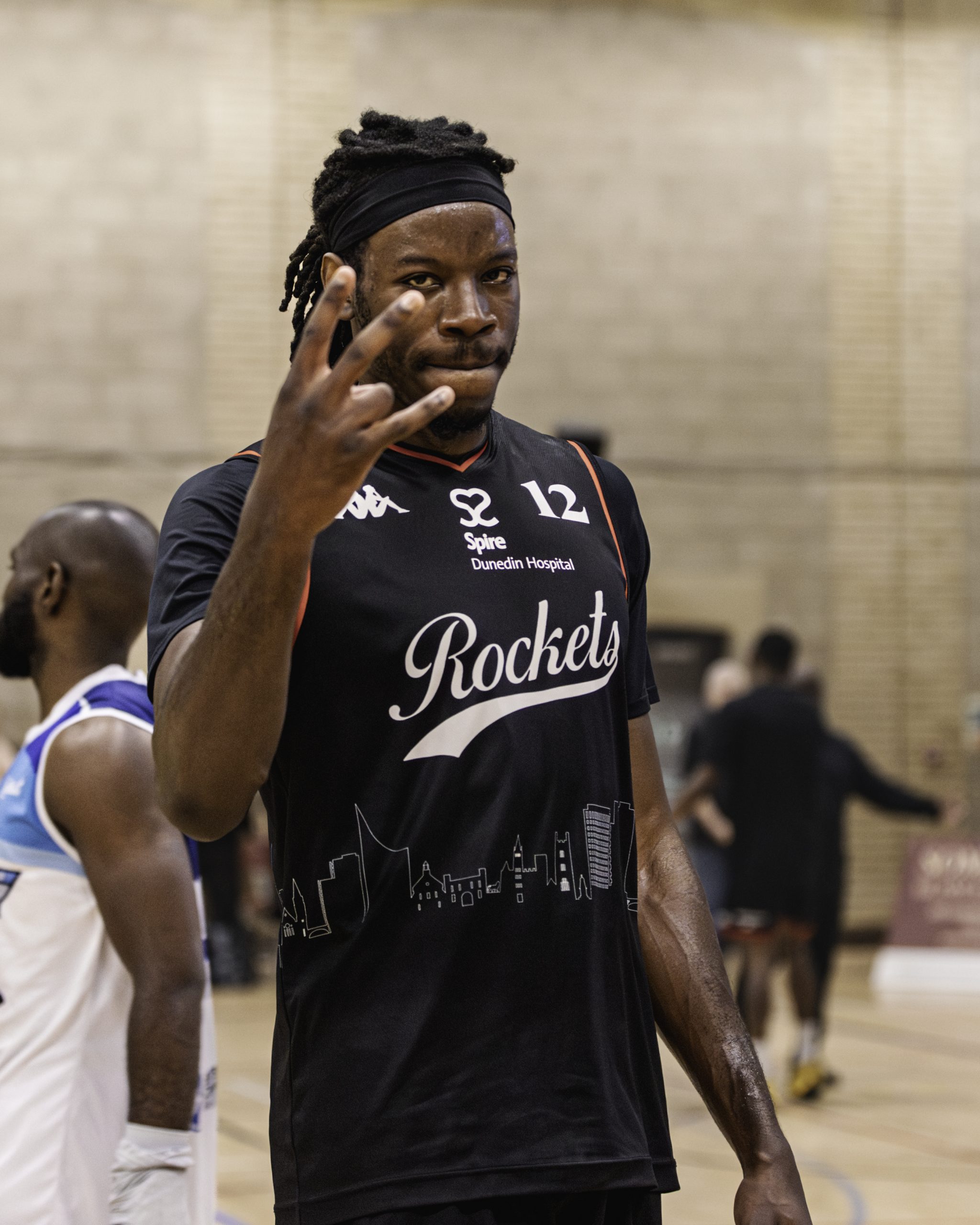Picture of Ty Nsangu reaching up towards a basketball